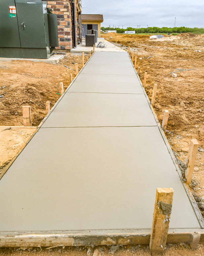 Concrete sidewalk added to a residential home in South Texas